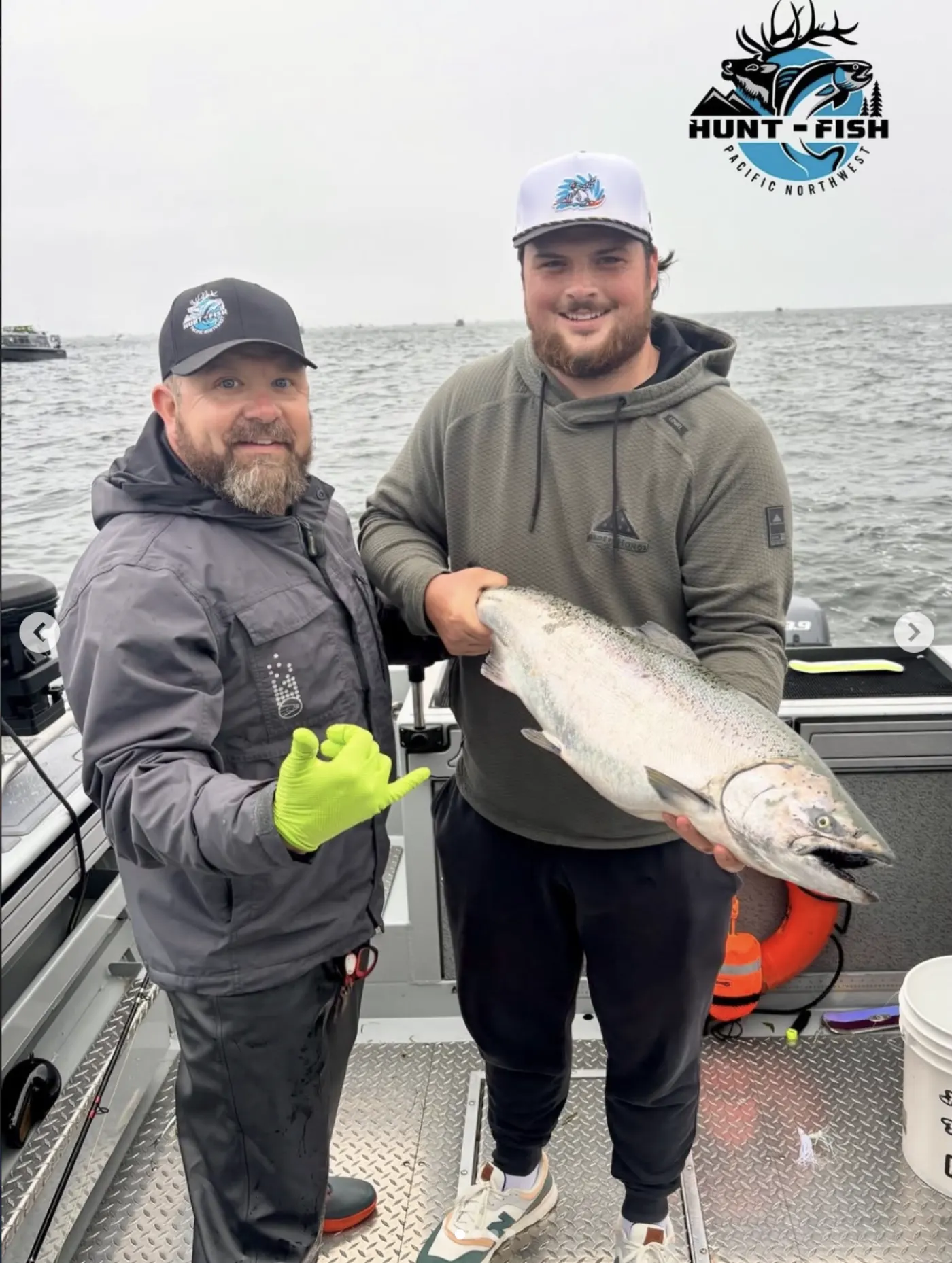 Happy guest with a bright salmon aboard the full private charter
