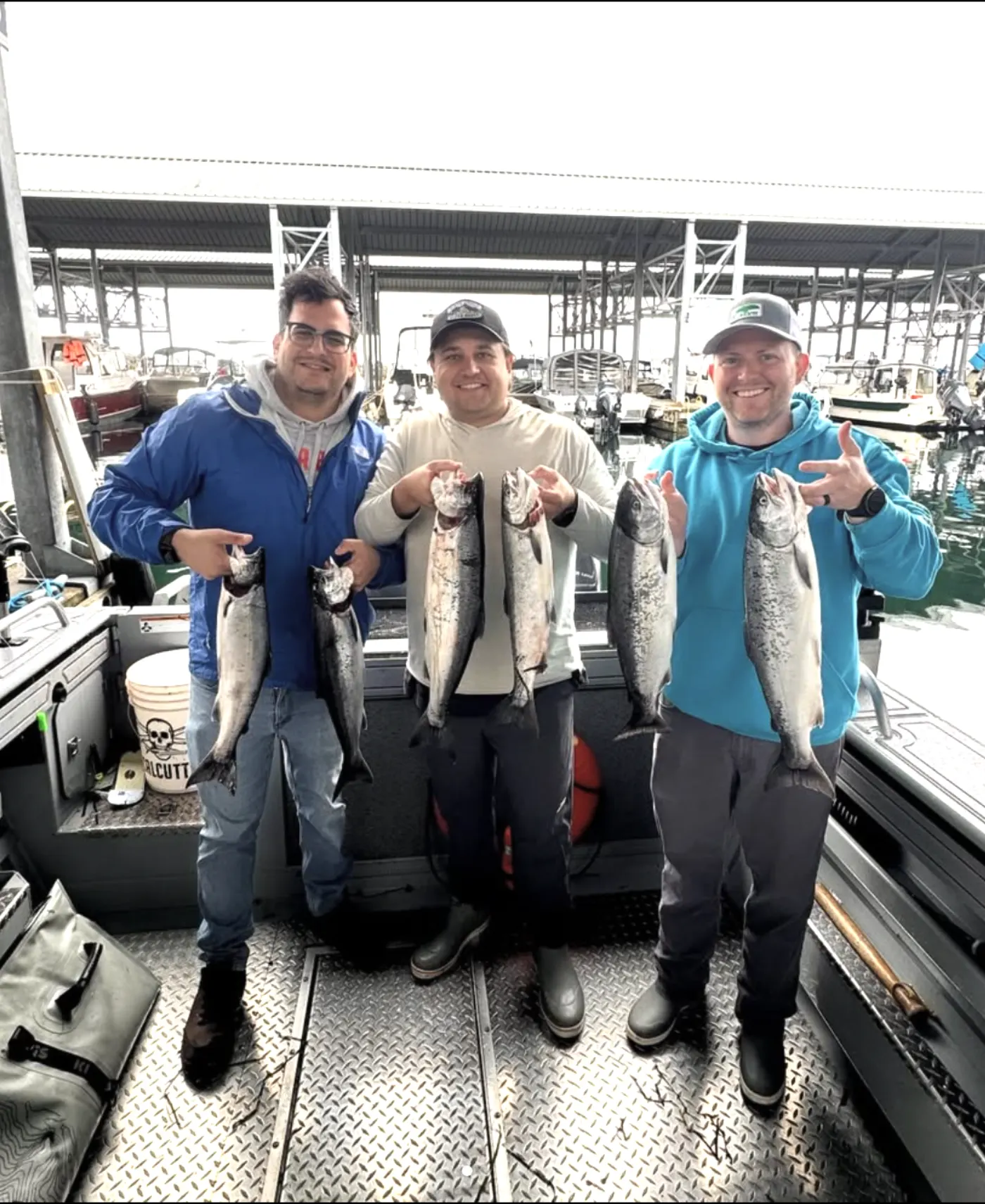 Guests holding their catch on a private Puget Sound charter